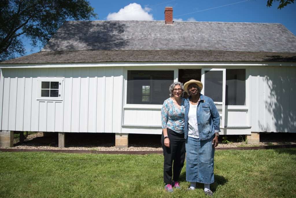 Maral Kalbian and Geneva Jackson pose in front of a building that once quartered enslaved laborers at Clermont Farm in Clarke County. Photo by Peter Hedlund